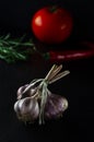 Harvest. A bunch of garlic lies on a black background close-up Royalty Free Stock Photo