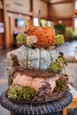 Harvest display of pumpkins featuring a vibrant arrangement of stacked gourds