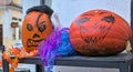 Harvest festival, bright orange patterned pumpkins are located on the city street.