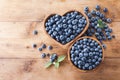 Harvest of fresh blueberries in bowl on wooden top view. Organic superfood and healthy berry Royalty Free Stock Photo