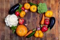 Harvest of fresh farm vegetables is laid out in oval on old rustic wooden table. Top view. Copy space Royalty Free Stock Photo