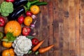 Harvest of fresh farm vegetables on old rustic weathered vintage wooden table. View above. Copy space Royalty Free Stock Photo