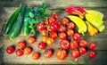 Harvest of fresh ripe vegetables on wooden table - pepper, tomato, cucumber, celery leaves. Royalty Free Stock Photo