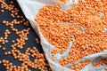 Harvest fresh scattered corn of lentils on parchment paper and a black background Royalty Free Stock Photo