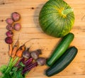 Harvest of fresh vegetables on wooden background. Top view. Potatoes, carrot, squash, peas, tomatoes