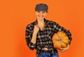 Harvest in garden. Homegrown pumpkin. Organic farming. Family farm. Woman rustic farmer presenting pumpkin. Farming and