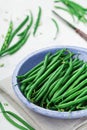 Harvest of green or string beans in rustic bowl on white table. Organic and diet food. Royalty Free Stock Photo