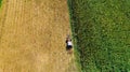 Harvest of hay, tractor using rotary rakes on agriculture crops. Aerial view, drone view