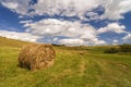 A harvest landscape vista in rolling hills in Romania with round Royalty Free Stock Photo