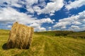 A harvest landscape vista in rolling hills in Romania with round Royalty Free Stock Photo