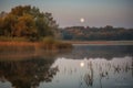 harvest moon reflections on the calm surface of a lake Royalty Free Stock Photo