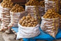 Harvest raw potatoes in burlap sack in market Royalty Free Stock Photo