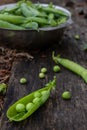 Harvest of ripe pods of green peas.Fresh green peas pods on a wooden board Royalty Free Stock Photo