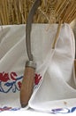 Harvesting symbol stack of grain covered with a traditional carpet and a sickle