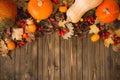 Harvest or Thanksgiving background with autumnal fruits and gourds on rustic wooden table Royalty Free Stock Photo