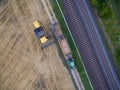 Harvest of wheat with tractor and trailor in the summer Royalty Free Stock Photo