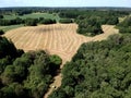 Harvested meadow panorama with drying hay grass, aerial