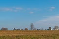 Harvested field of corn, with trees and an Amish farm house, on a beautiful day with blue sky, Lancaster County, PA Royalty Free Stock Photo