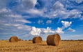 Harvested field with straw bales in summer Royalty Free Stock Photo