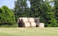 Harvested and wrapped giant round hay bales wait for transport Royalty Free Stock Photo