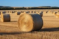 Harvested gold Hay bales punctuate the picturesque agricultural scenery