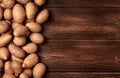 Harvested pile of potatoes on old wooden board table. Food or vegetables for cooking