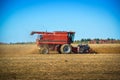 Harvester harvesting corn in a field in the fall in Quebec Royalty Free Stock Photo