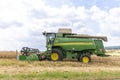 Harvester John Deere Hillmaster at the field in operation Royalty Free Stock Photo