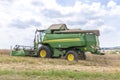 Harvester John Deere Hillmaster at the field in operation Royalty Free Stock Photo