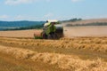 Harvester machine to harvest wheat field working. Agriculture Royalty Free Stock Photo