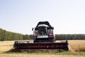 Harvester machine to harvest wheat field working. Combine agriculture harvesting golden ripe . Royalty Free Stock Photo