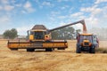 Harvester machine and tractor at harvest