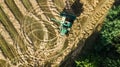 Harvester machine working in field aerial view from above, combine harvester agriculture machine harvesting ripe wheat field Royalty Free Stock Photo