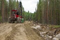 Harvester machines working in a forest moving thrue the forest track. Wood industry