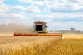 Harvester maschine on gold field cut wheat Royalty Free Stock Photo
