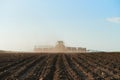 Harvester plowed soil sows seeds Royalty Free Stock Photo