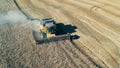 Harvester is reaping wheat in the field in a top view