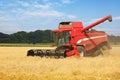 Harvester on wheat field, harvesting