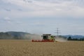 A harvester on a wheat field in summer during harvesting Royalty Free Stock Photo