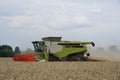 A harvester on a wheat field in summer during harvesting Royalty Free Stock Photo