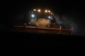 Harvester at work on field at night Royalty Free Stock Photo