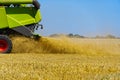 Harvester in work at summer hot day. Royalty Free Stock Photo