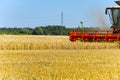 Harvester in work at summer hot day. Royalty Free Stock Photo