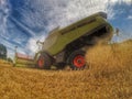 Harvester at work in summer sun Royalty Free Stock Photo