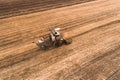 Harvester working in field and mows wheat. Ukraine. Aerial view. Royalty Free Stock Photo