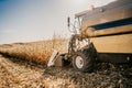 Harvester working in the fields. Farmer using combine machinery, industrial agriculture Royalty Free Stock Photo