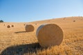 Harvestimg in Tuscany, Italy. Stacks of hay on summer field. Hay and straw bales in the end of summer Royalty Free Stock Photo