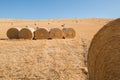 Harvestimg in Tuscany, Italy. Stacks of hay on summer field. Hay and straw bales in the end of summer Royalty Free Stock Photo