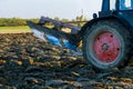 After harvesting the autumn field, the tractor ploughs it with its plow