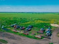 Harvesting combines in the green field. Drone view.